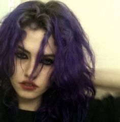 a close up of a person with purple hair