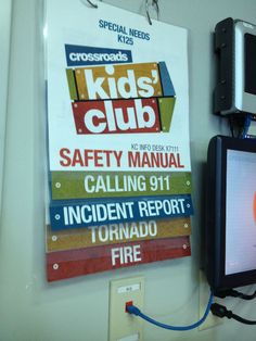 there is a sign on the wall that says kids'club safety manuals hanging up