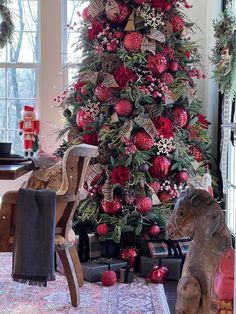 a christmas tree decorated with red and gold ornaments