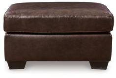 a brown leather ottoman with wooden legs and footrests on an isolated white background