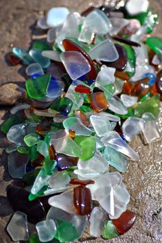 many different colored glass pieces laying on the ground