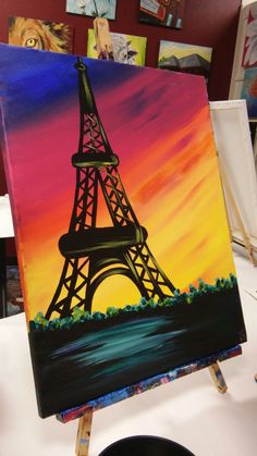 a painting of the eiffel tower is on display at an art show in paris