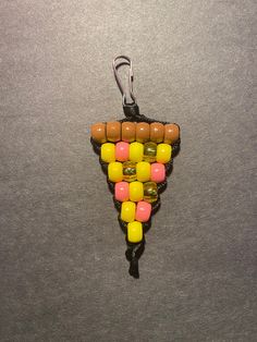 a wine bottle shaped keychain with candy in it on a gray surface,