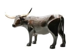 a statue of a bull with large horns on it's head and tail, standing in front of a white background