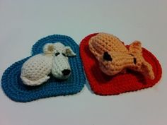 two crocheted animals laying on top of each other in the shape of hearts