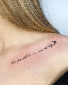 a woman's back shoulder with an arrow tattoo that says, life is like the journey