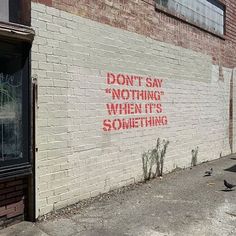 graffiti on the side of a building that says don't say nothing when it's something