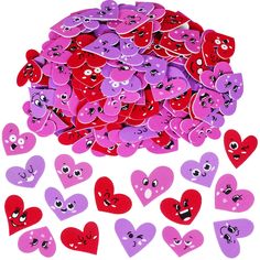 a pile of purple and red heart shaped buttons with eyes on each one, surrounded by smaller hearts