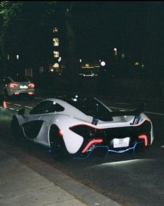 a futuristic car is parked on the side of the road