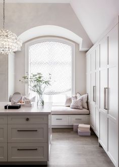 a white kitchen with lots of counter space and furniture on it's instagram page