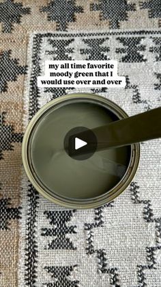 a can of green paint sitting on top of a rug with the words, my all time favorite moody green that i wonder over another