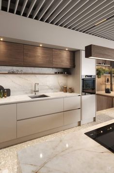 a modern kitchen with marble counter tops and wooden cabinetry, along with an oven