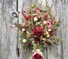 a bouquet of flowers sitting on top of a wooden table