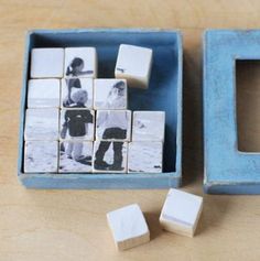 two blue boxes filled with white cubes next to each other on top of a wooden table