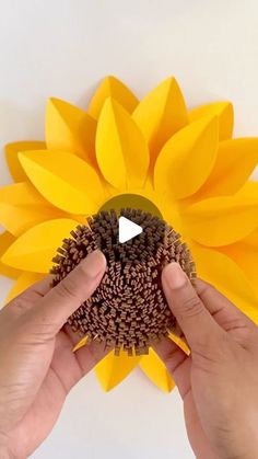 someone is making a sunflower out of construction paper