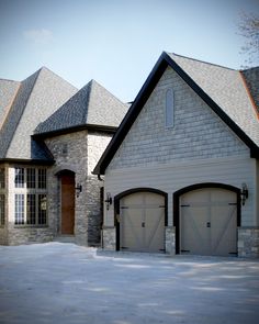 a large house with two garages in front of it