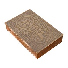 an intricately carved wooden box on a white background