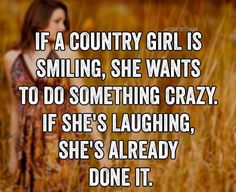 a woman standing in tall grass with the caption if a country girl is smiling, she wants to do something crazy