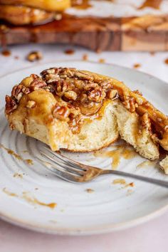 a piece of pecan pie on a plate with a fork