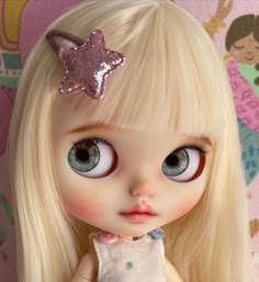 a close up of a doll with blonde hair