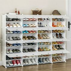 a white shoe rack filled with lots of shoes