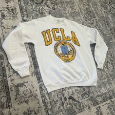 Rare Vintage 80s Ucla Bruins Discus Athletic White Crewneck Size L Pre-Owned Condition Tag Size - Large Measurements In Photos For Accurate Sizing Made In Usa This Is An Absolute Must Have For Any Ucla Fan Some Flaws On The Bottom Of Back Check All Photos For Details/Flaws !! Disclaimer !! - Please Be Aware That Vintage/Used Items Will Not Be In New Condition Unless Specifically Stated. Some Items May Have Flaws, Discoloration, Or Other Imperfections That Are Commonly Present In Vintage/Used Items. Ucla University, Ucla Bruins, White Crewneck, Sweaters Crewneck, Sweater Top, Made In Usa, Men Sweater, Im Not Perfect, Mens Accessories