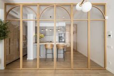 an open concept living room and dining area with glass doors leading to the kitchen island