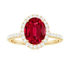 an oval shaped ruby and diamond ring in yellow gold