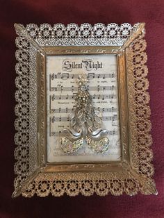 a silver frame with music notes and a christmas tree