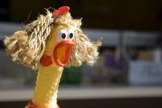 a close up of a stuffed animal toy with a hairdow on it's head