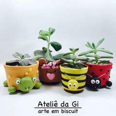 four pots with plants in them on a white background and the words atelle da gi are em biscuit