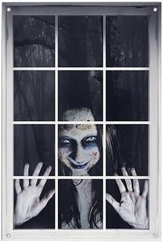 a woman with painted face and hands is looking through a window at the trees outside