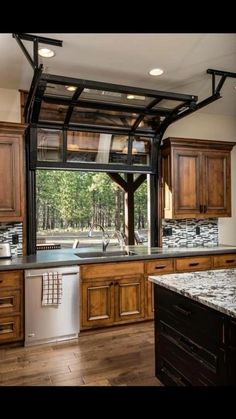 an open kitchen with wooden cabinets and stainless steel appliance on the left side