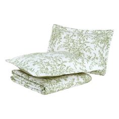 two green and white pillows on top of each other