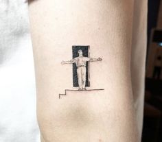 a person with a cross tattoo on their arm