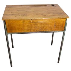 an old wooden desk with metal legs and a drawer on the top, against a white background