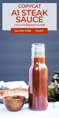 a jar filled with sauce next to a bowl