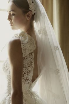 a woman wearing a wedding dress and veil