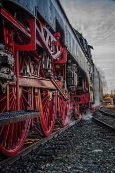 an old steam engine is on the tracks