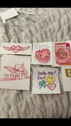 several cards are laid out on a bed