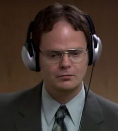 a man wearing headphones and a suit