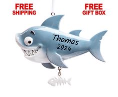 a christmas ornament with a shark on it and the words thomas's 2012