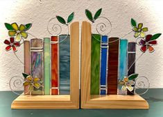 a wooden bookend with stained glass flowers and leaves