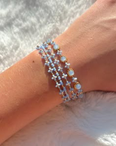 A dainty flower bracelet of blue and gold, sold in three different styles. It is adjustable and durable for everyday wear. (The length of the bracelet at the longest setting is 7.5 inches, please message me if you would like a longer chain!)