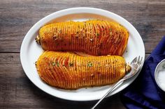 two cooked sweet potatoes on a white plate