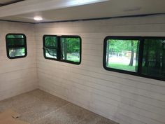 the inside of a mobile home with three windows