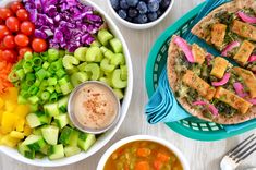 bowls of vegetables, tofu and other foods are on the table next to each other