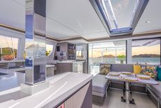 the interior of a boat with lots of windows and furniture on it's sides