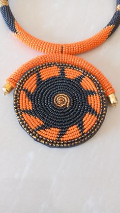 African Necklace, African Jewelry, African Beaded Necklace, Zulu Beaded Necklace, Orange Necklace, Pendant Necklace, Gift For Her This stunning pendant necklace is superbly crafted which makes you stands out in any occasion. Main Color - Orange. Different colors of your choice can be available. Wholesale available at a fair price. For any query please send me a convo or an e-mail. Happy Shopping Handmade Orange Beaded Pendant Necklace, Artisan Black Beaded Necklaces For Jewelry Making, Traditional Orange Jewelry With Black Beads, Orange Beaded Pendant Necklace, Orange Spacer Beads For Jewelry Making, Artisan Orange Beaded Necklaces, Artisan Beaded Pendant, Orange Beaded Round Necklace, Orange Necklace With Black Beads For Gift