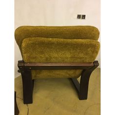 a green chair sitting on top of a wooden table